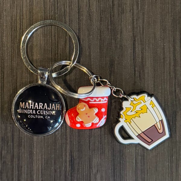 Maharajah India Cuisine keychain with a Christmas stocking and beer mug charm.