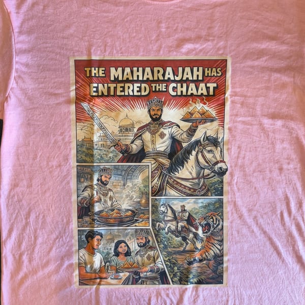 Pink t-shirt with a comic-style print featuring an Indian Maharajah, samosas, and a tiger.